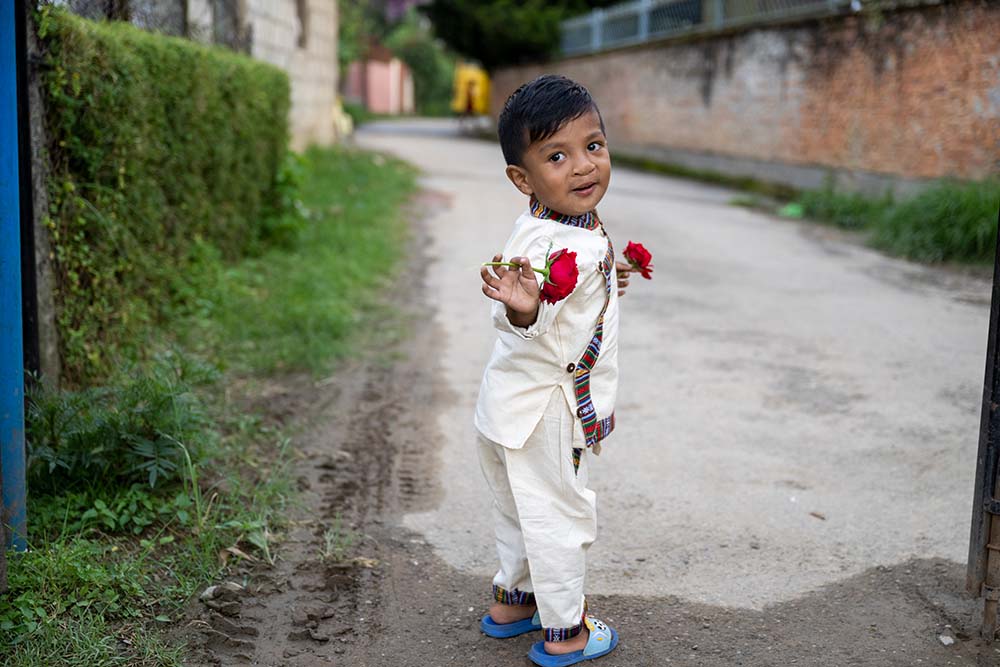 Asher playing with a couple of flowers