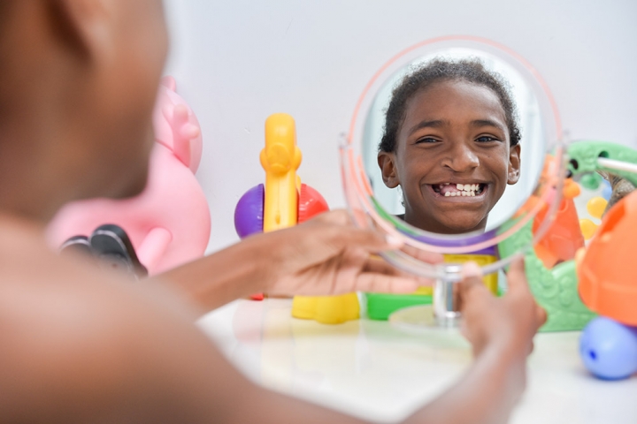 Girl looks at herself in mirror