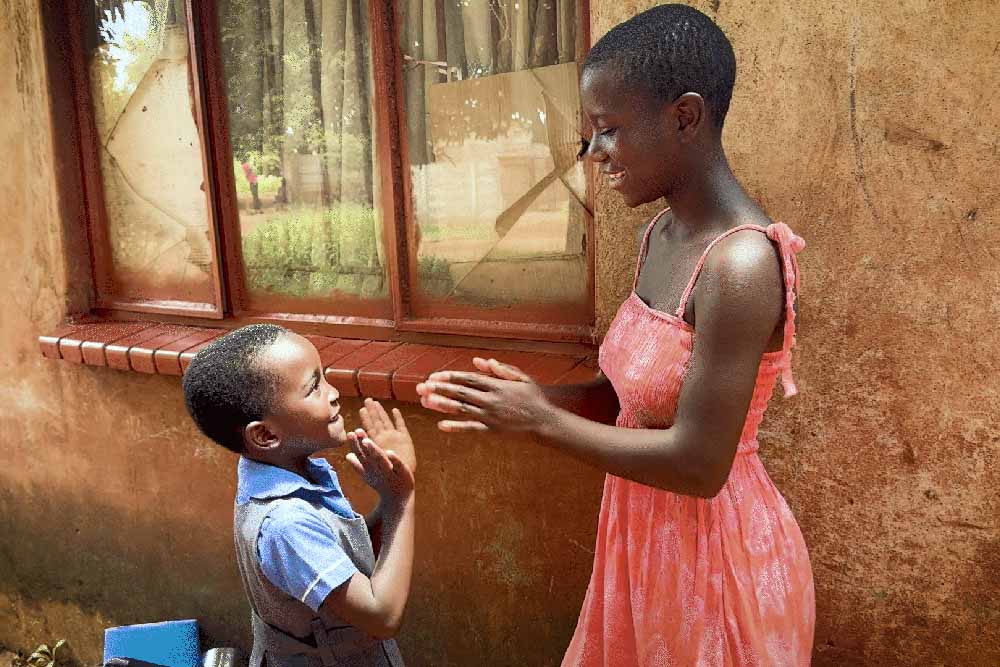 Talent and Mercy playing pat-a-cake